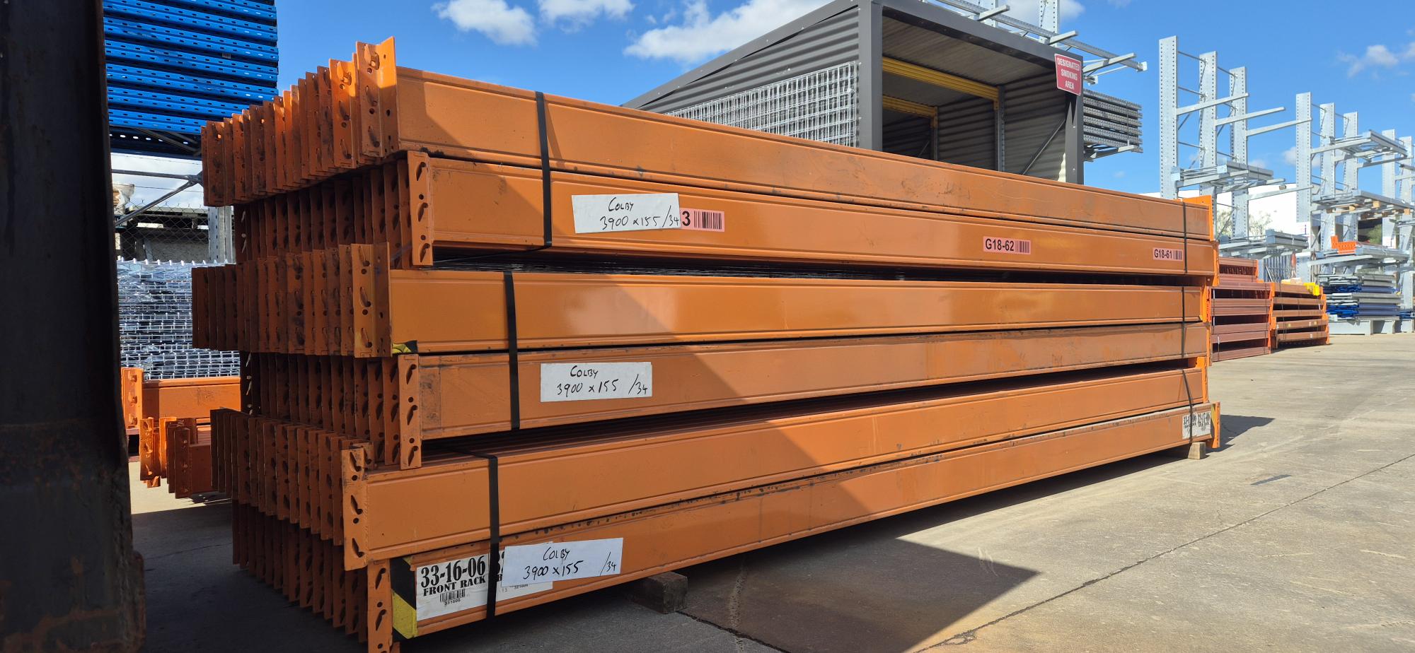 Second hand Colby pallet racking beams 3900mm x 155mm stacked in yard, orange beams with 2800kg load capacity available at ReadyRack