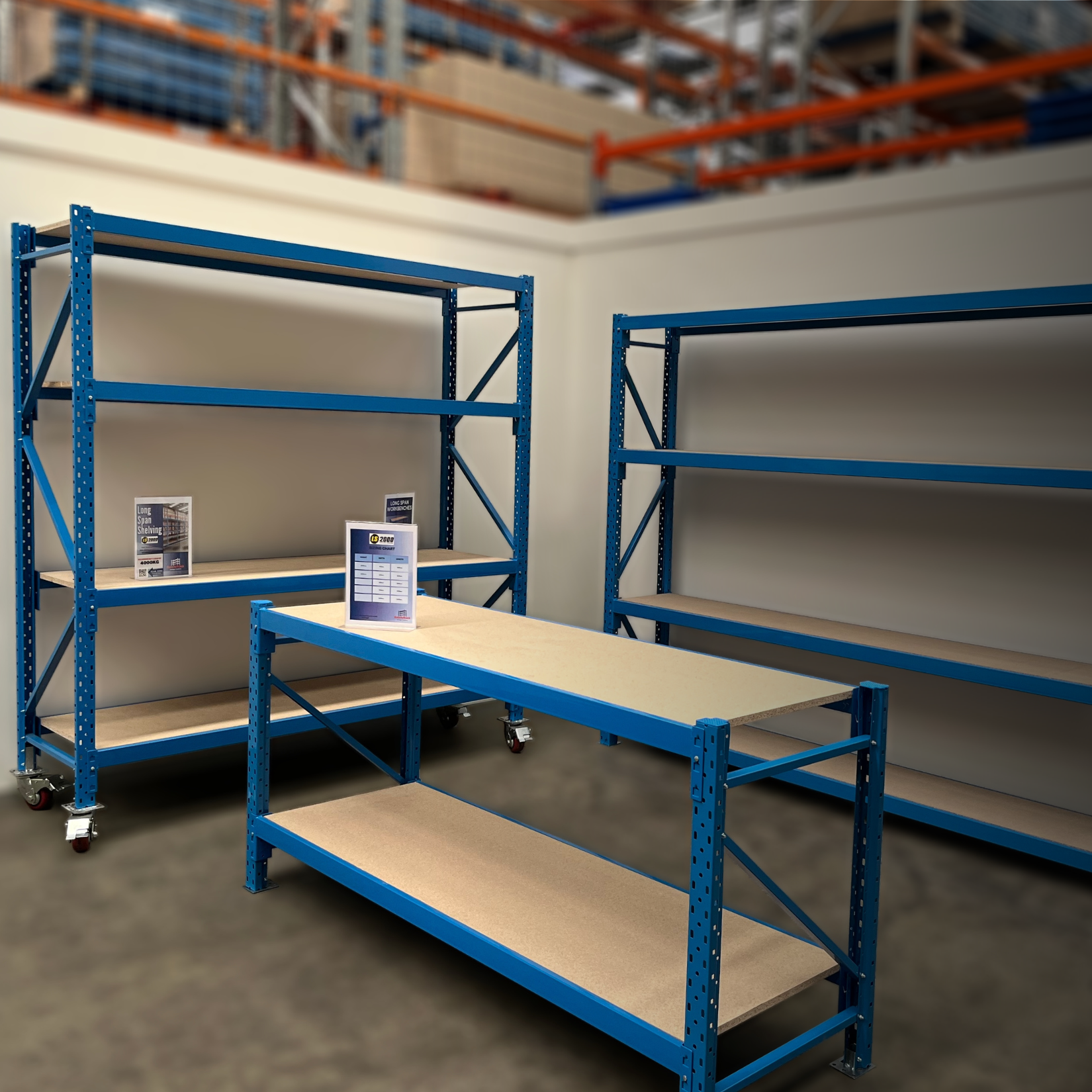 Blue Longspan Shelving and workbench with chipboard in a workshop/warehouse
