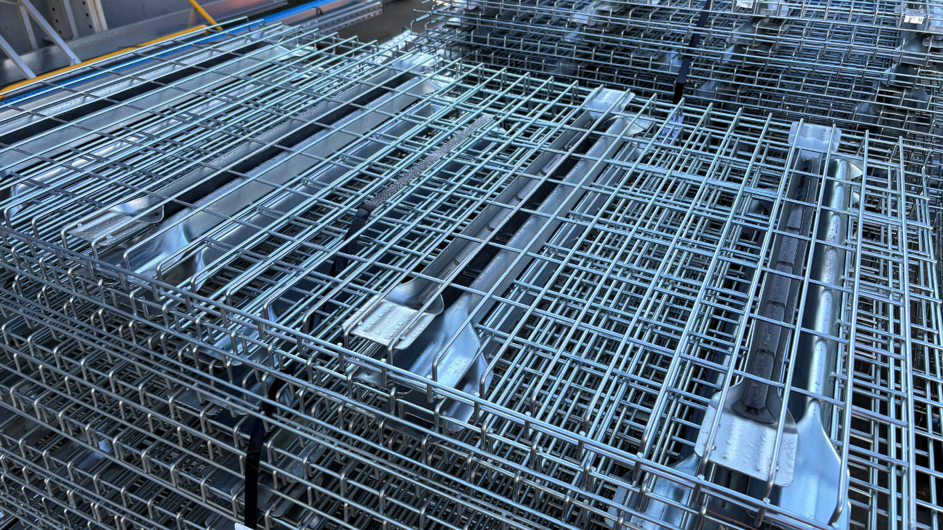 Heavy duty galvanised wire mesh decking stacked on pallets in warehouse, suitable for pallet racking systems and warehouse storage shelving