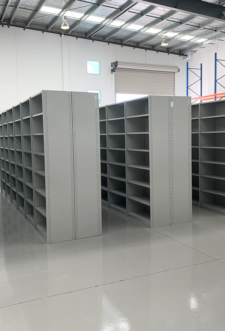 Large metal shelving units in a warehouse setting